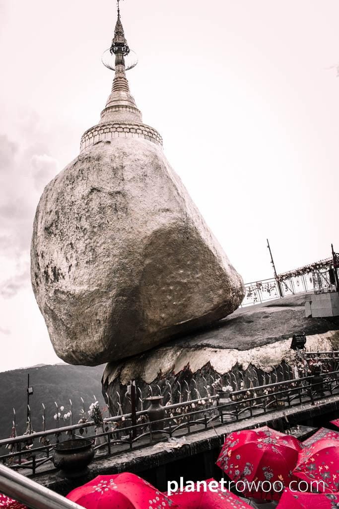 Umbrellas protect pilgrims from the rain at the Golden Rock