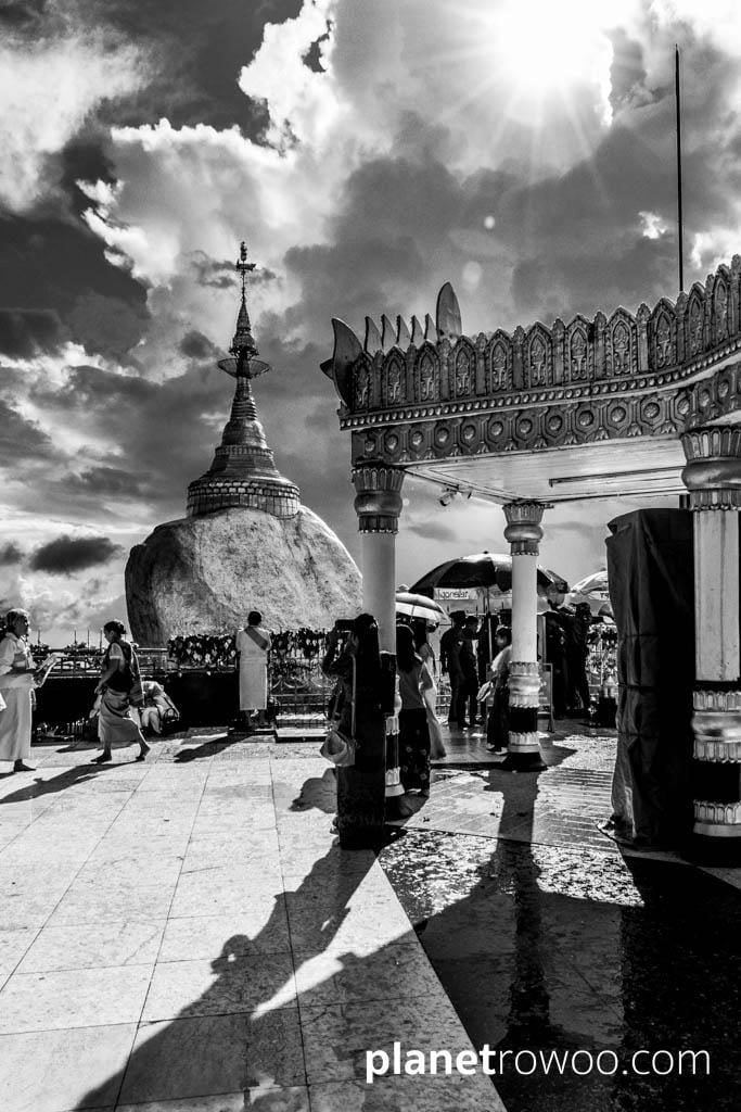 The sun breaks through the clouds at Golden Rock