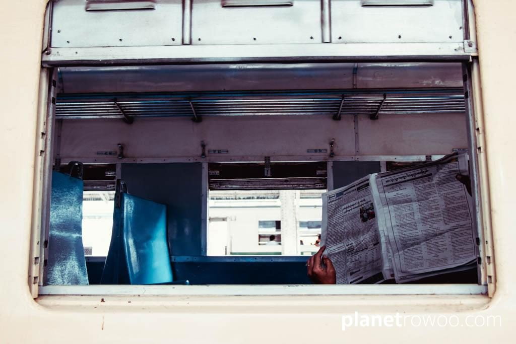 Newspaper through Yangon Central carriage window