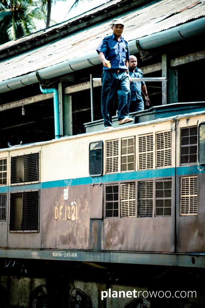 Rail workers on top of a locomotive, Yangon Central station