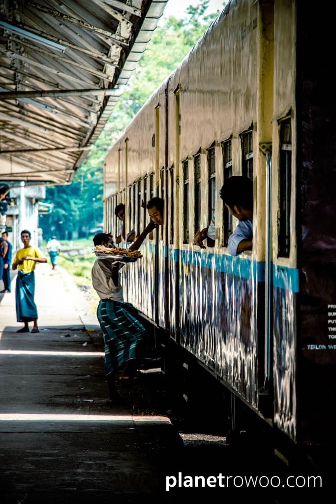 Food vendor proffering snacks at Yangon Central station