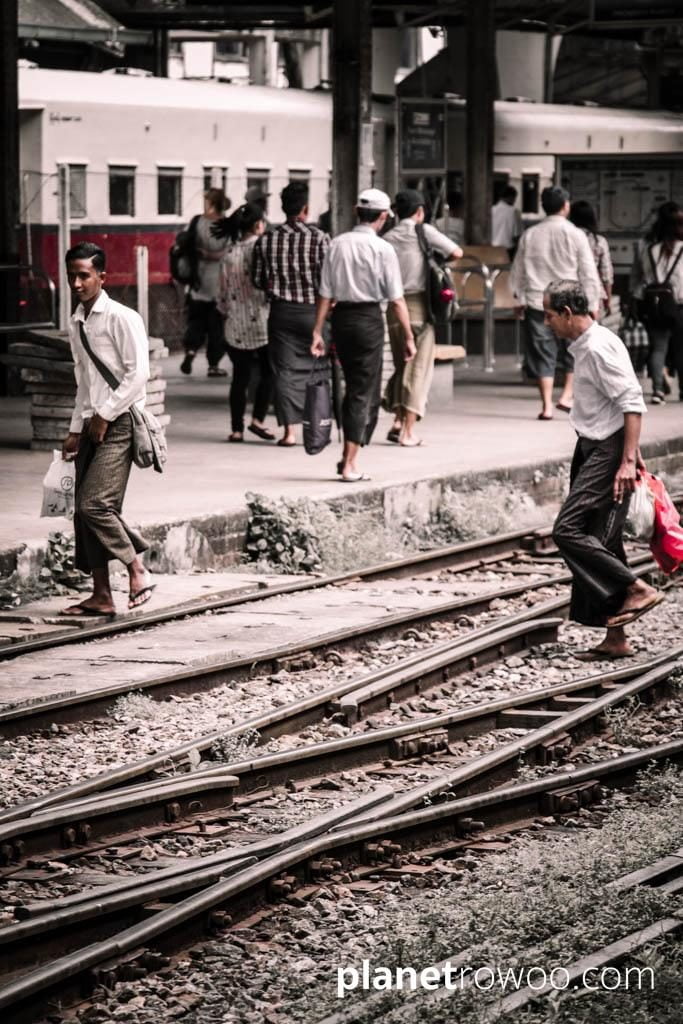 Locals cross the tracks at Yangon Central station