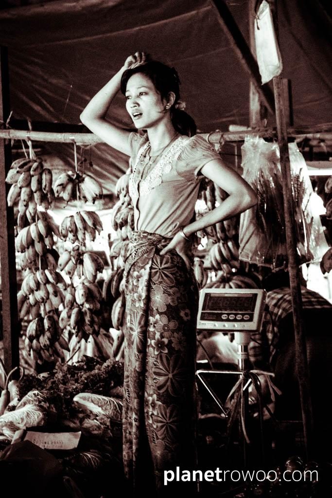 Vegetable vendor stands amongst her wares, Nyaung U market