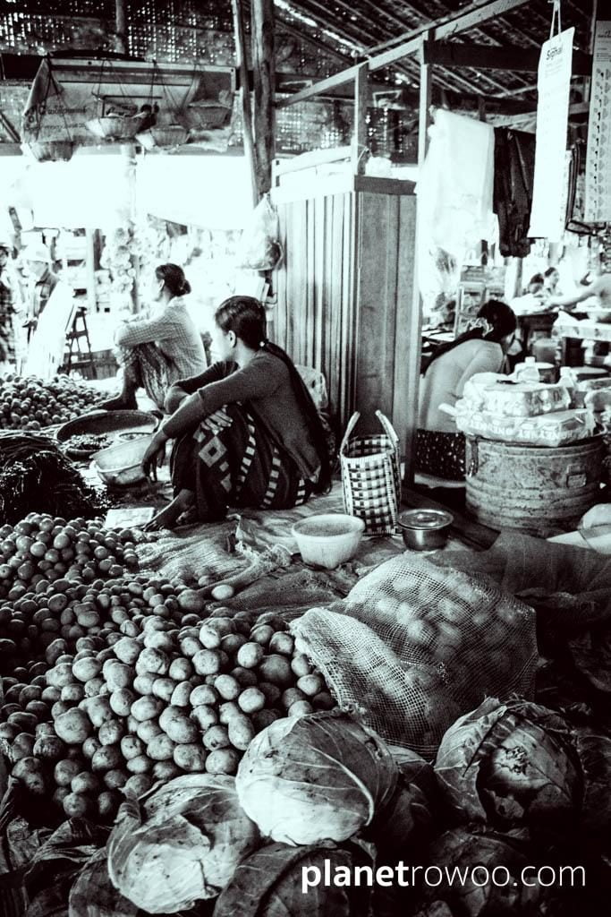 Nyaung U market vendors sit amongst their goods
