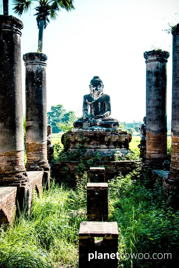 Buddha image amid the ruins at Yedanasimi Pagoda