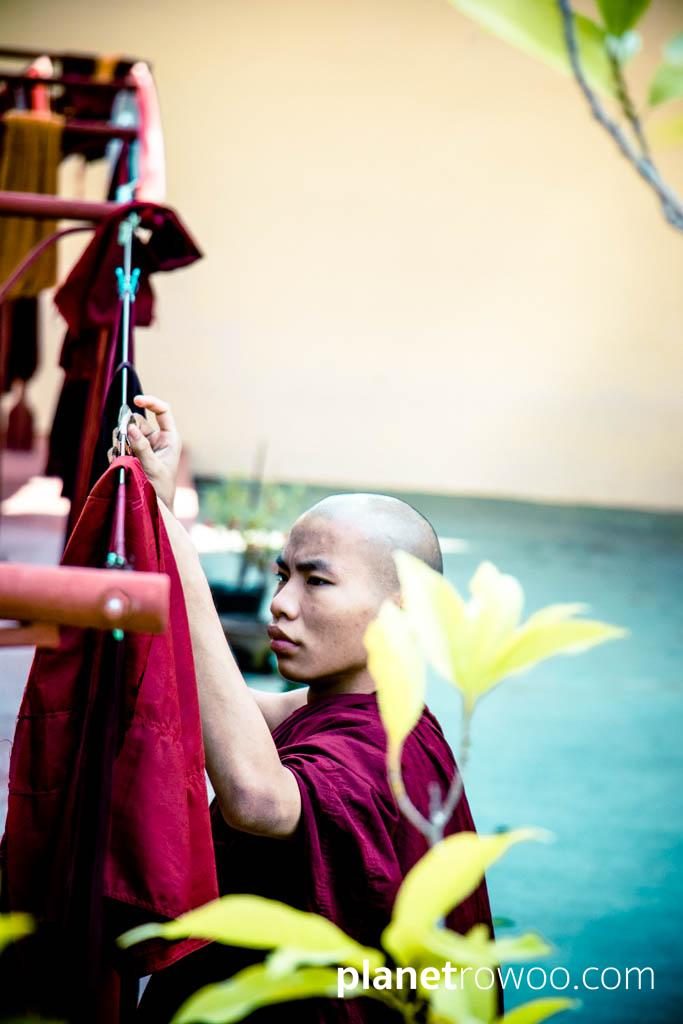 A monk hangs his robe to dry