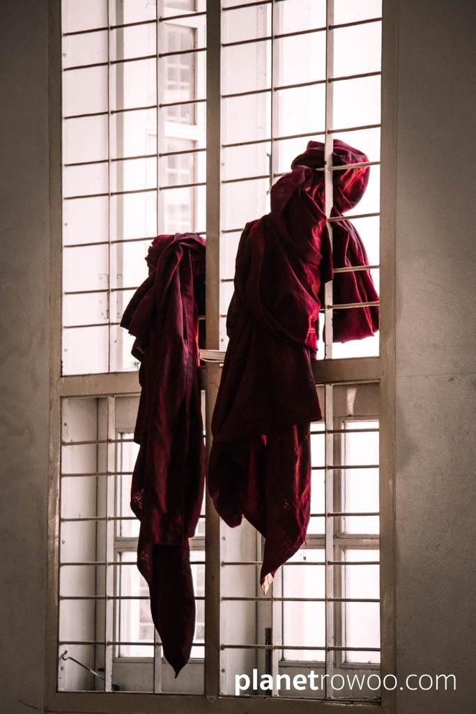 Monks robes hanging in window