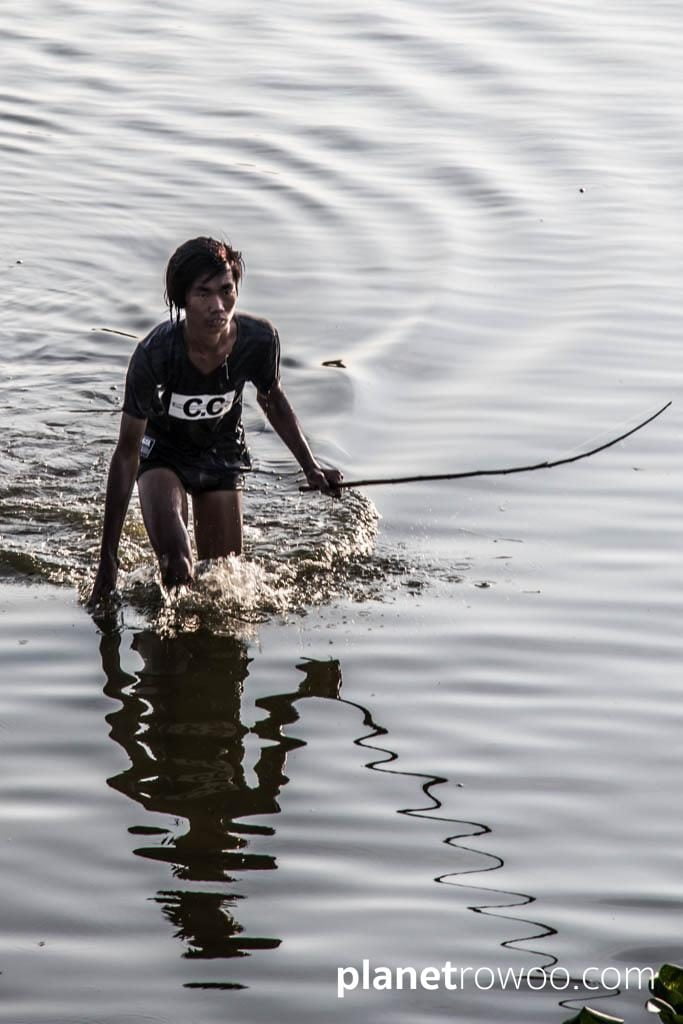 Fisherman in the shallow waters around U Bein Bridge