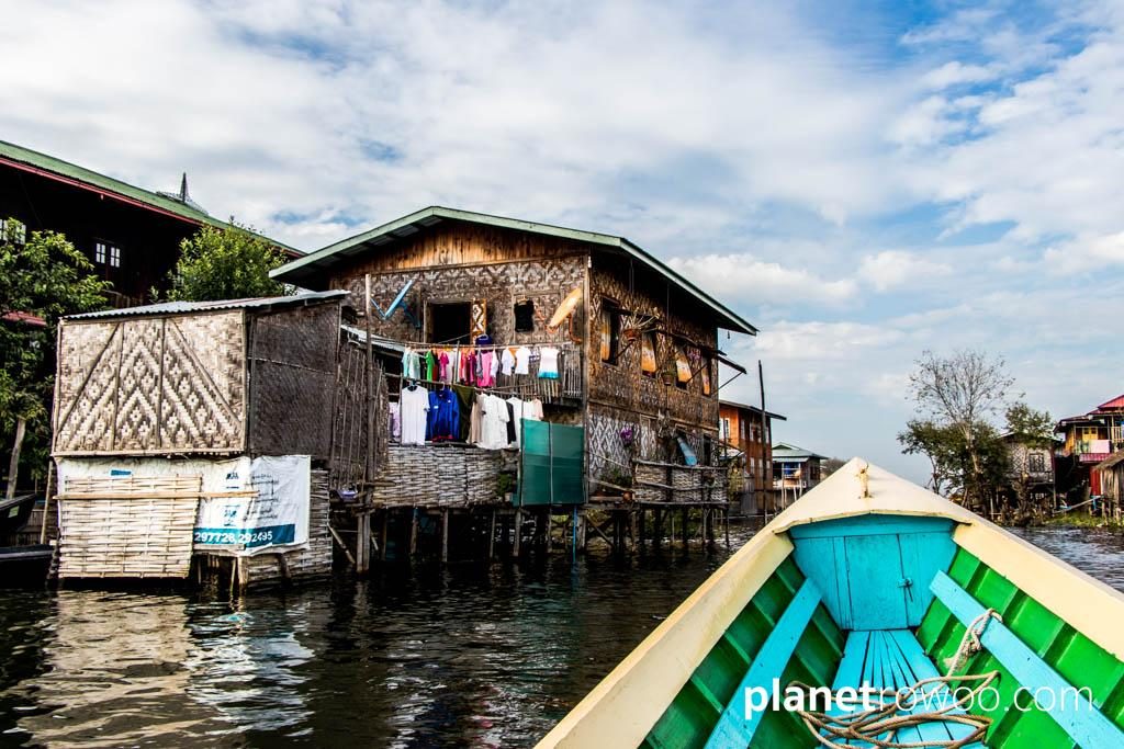 Passing a village house on Inle Lake