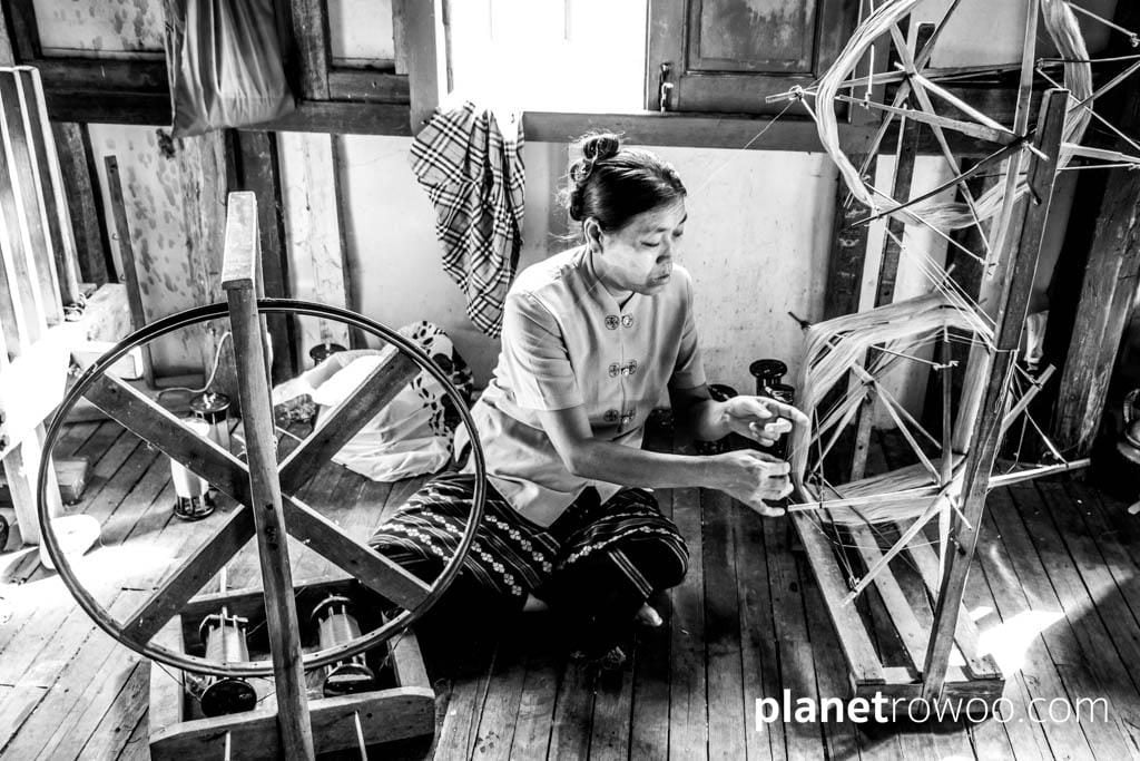 Spinning the silk thread on a spinning wheel, Inpawkhone weaving village