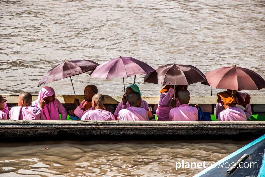 Nyaung Shwe nuns, shading from the sun under umbrellas