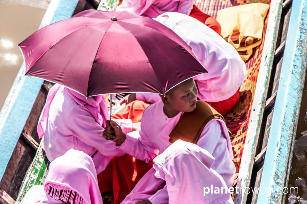 Nyaung Shwe nun, shading from the sun under an umbrella
