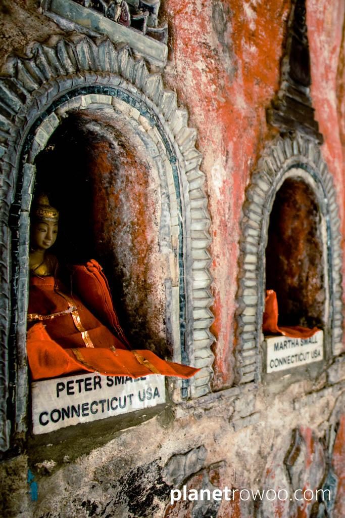 Red-robed Buddhas in niches of the Shwe Yan Pyay shrine donated by pilgrims from around the world