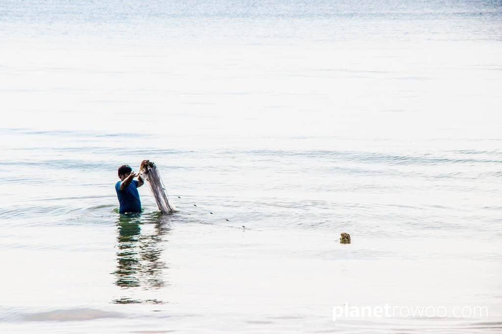 Fisherman in Bangsak Beach ocean, Khao Lak