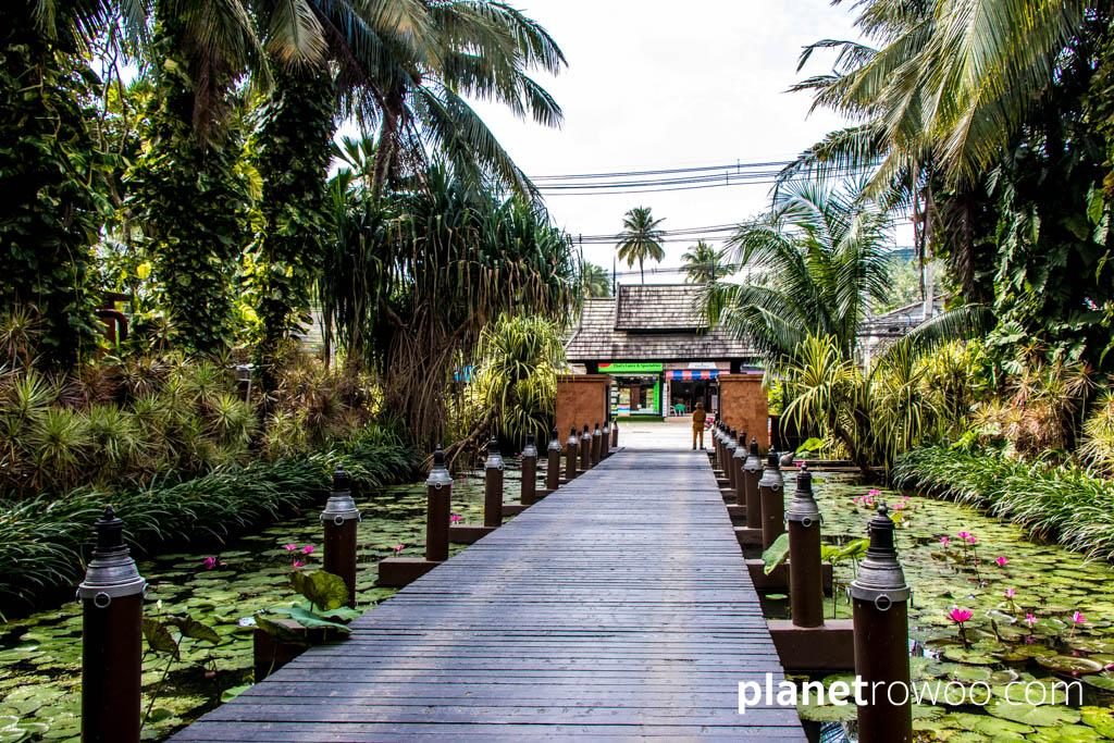 Flame torches line the Anantara Bophut wooden bridge entrance