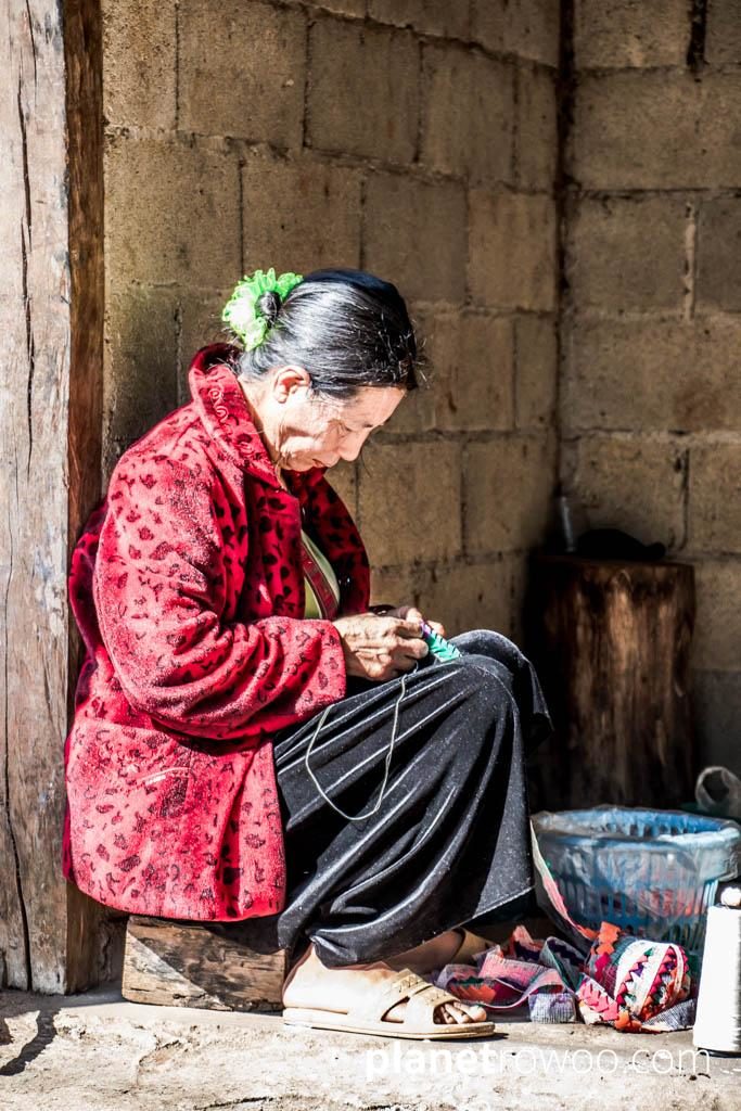 Lisu hill tribe villager sewing traditional wares