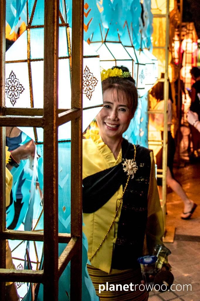 A Lanna candle dancer enjoys the Yee Peng Lantern Displays at Three Kings Monument, Chiang Mai