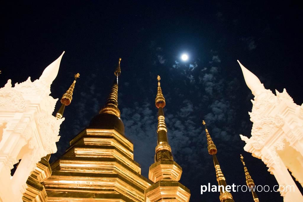 The full moon appears above the Chedi at Wat Phan Tao in Chiang Mai, on the night of the Yee Peng ceremony