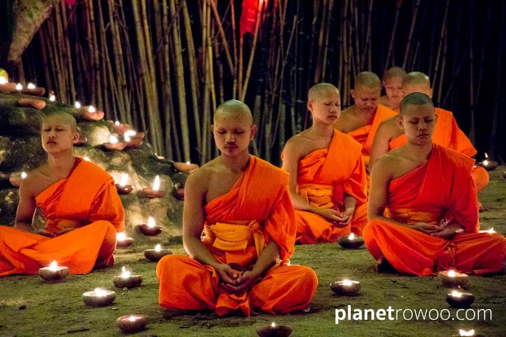 Novice monks meditate during the Yee Peng festival at Wat Phan Tao