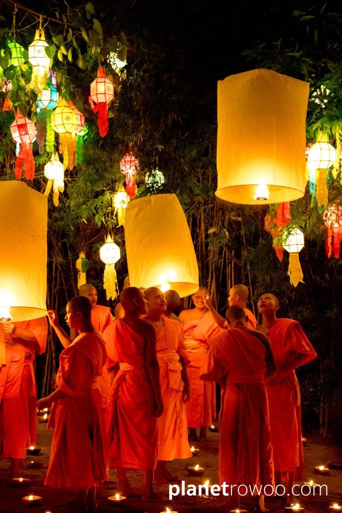 Novice monks release sky lanterns at Wat Phan Tao during the Yee Peng festival in Chiang Mai