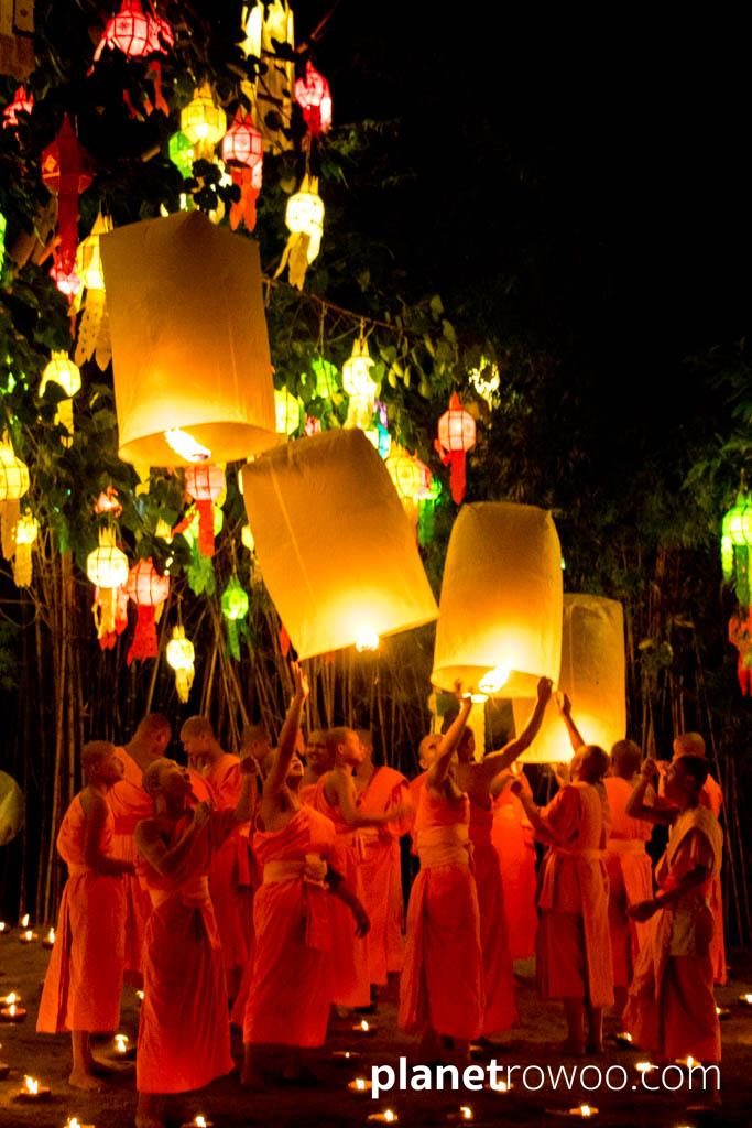 Novice monks release sky lanterns at Wat Phan Tao during the Yee Peng festival in Chiang Mai