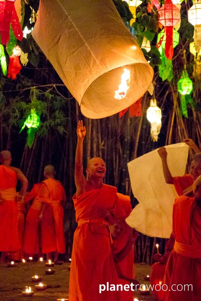 Novice monks release sky lanterns at Wat Phan Tao during the Yee Peng festival in Chiang Mai