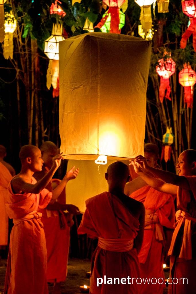 Novice monks release sky lanterns at Wat Phan Tao during the Yee Peng festival in Chiang Mai
