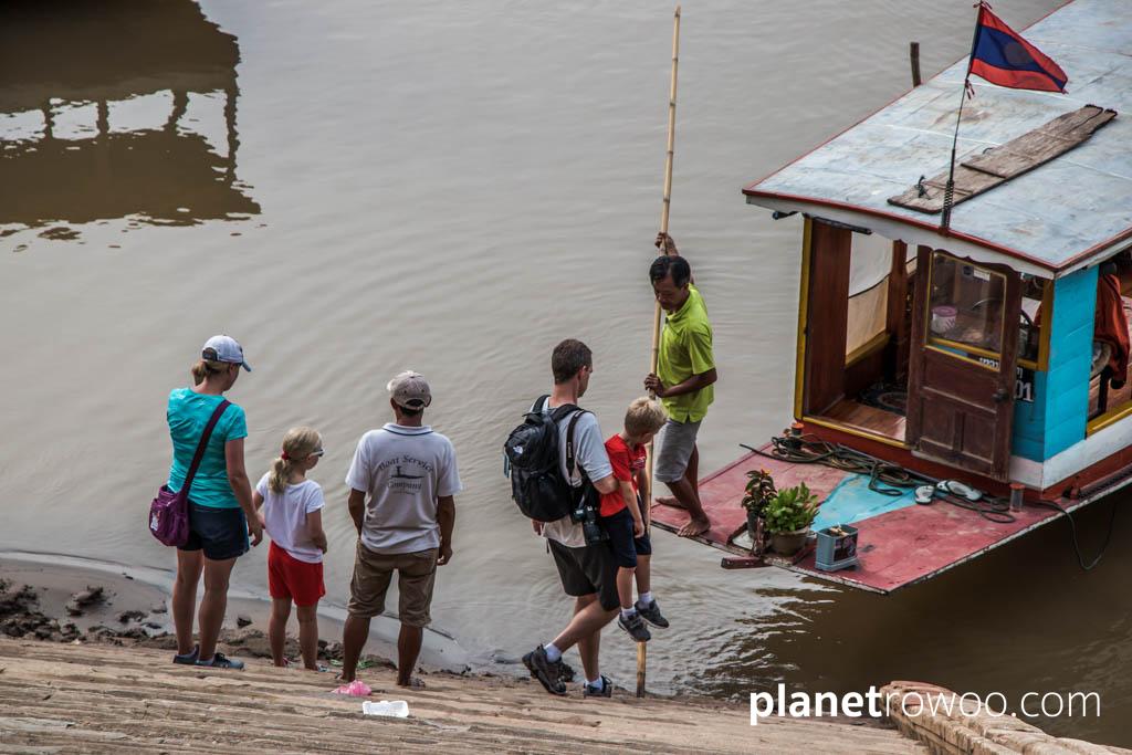 Boarding a Mekong riverboat at Luang Prabang, Laos