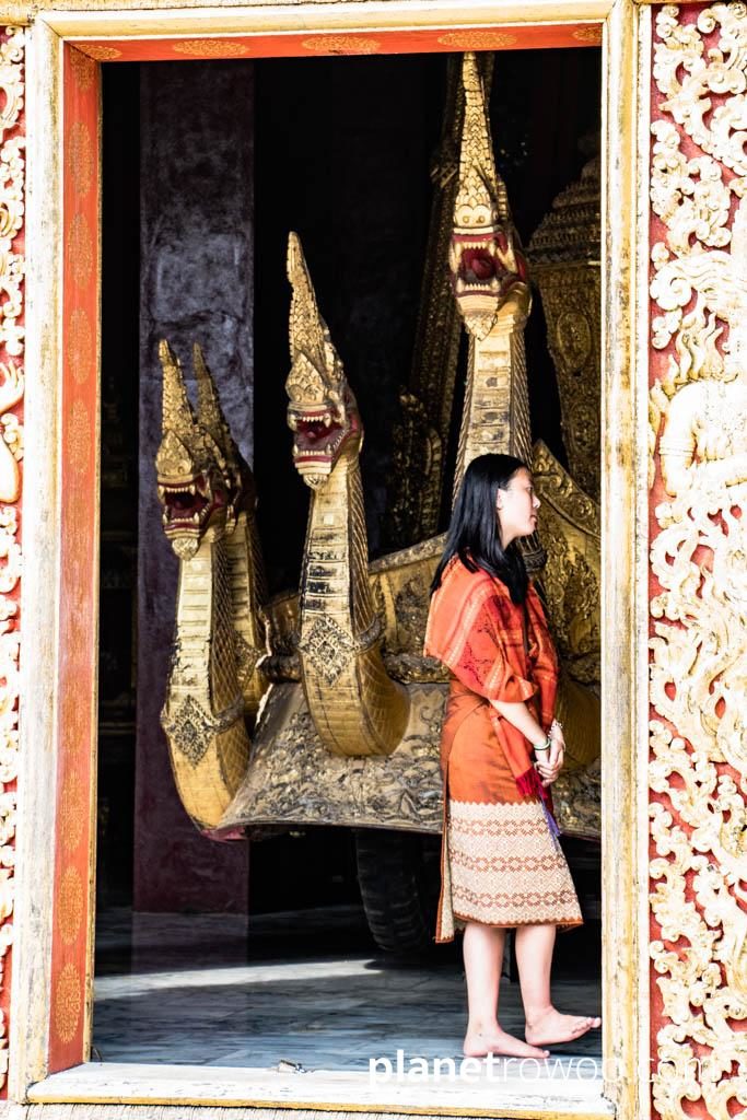 Naga royal funeral carriage seen through the doorway of the Chariot Hall at Wat Xieng Thong, Luang Prabang, Laos