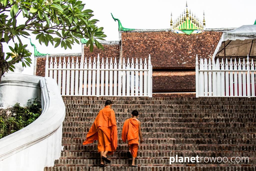 The entrance of Kings – Novice monks climb the broad stairway up to Wat Xieng Thong from the banks of the Mekong, Luang Prabang, Laos